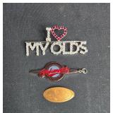 Collection of Vintage Oldsmobile Pin Badges and Souvenir