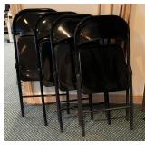 Four Black Folding Chairs