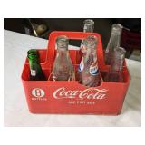Collection of Vintage Soda Bottles with Coca-Cola Carrier