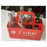 Collection of Vintage Soda Bottles with Coca-Cola Carrier