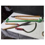 Collection of Gardening Tools Including Weed Cutter, Pruning Shears, and Hand Tools