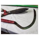 Collection of Gardening Tools Including Weed Cutter, Pruning Shears, and Hand Tools