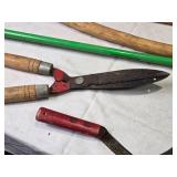 Collection of Gardening Tools Including Weed Cutter, Pruning Shears, and Hand Tools