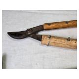 Collection of Gardening Tools Including Weed Cutter, Pruning Shears, and Hand Tools