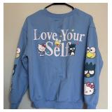 Two Blue Sweatshirts Including Peanuts and Hello Kitty