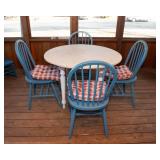 White Circle Table with Four Blue Chairs