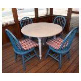 White Circle Table with Four Blue Chairs