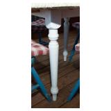 White Circle Table with Four Blue Chairs