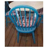 White Circle Table with Four Blue Chairs