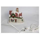 Snow-Covered Ceramic Holiday House with Lights