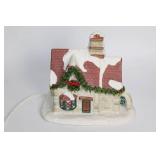 Snow-Covered Ceramic Holiday House with Lights