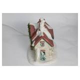 Snow-Covered Ceramic Holiday House with Lights