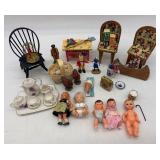 Collection of Vintage Miniature Dolls and Toy Tea Set with Floral Design