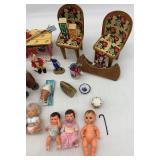 Collection of Vintage Miniature Dolls and Toy Tea Set with Floral Design