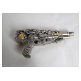 Silver-Colored Toy Ray Gun with Steampunk Design