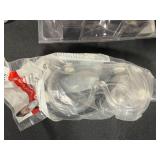 Safety Gear Collection Including Goggles, Ear Protection, and Pipe Clamp