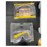 Safety Gear Collection Including Goggles, Ear Protection, and Pipe Clamp