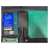 Collection of Office and School Supplies Including Notebooks, Legal Pads, and Cutting Mats