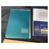 Collection of Office and School Supplies Including Notebooks, Legal Pads, and Cutting Mats