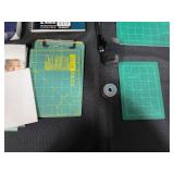 Collection of Office and School Supplies Including Notebooks, Legal Pads, and Cutting Mats