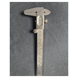 Collection of Drafting Tools including Vernier Caliper and Protractor