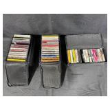 Collection of Music Cassettes and CDs in Case Logic Cases