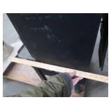 BLACK CAST IRON STOVE ON STAND WITH ROOF VENT