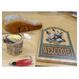 Vintage lure and clay pigeons, hide-a-key wood carving and welcome sign