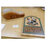 Vintage lure and clay pigeons, hide-a-key wood carving and welcome sign