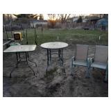 2 bar height glass top patio tables and 2 chairs