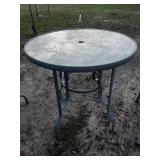 2 bar height glass top patio tables and 2 chairs