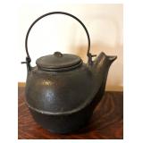 Two Teapots with Teacups including a Cast Iron Tea Kettle