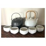 Two Teapots with Teacups including a Cast Iron Tea Kettle