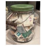 Four Glass Containers Full of Match Books