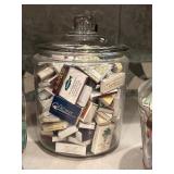 Four Glass Containers Full of Match Books