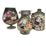 Four Glass Containers Full of Match Books