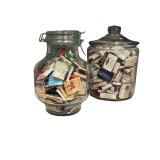 Four Glass Containers Full of Match Books