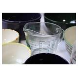 Collection of Assorted Bowls, Cups, and a Measuring Jug