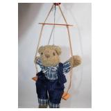 Plush Teddy Bear on Wooden Swing in Checked Outfit