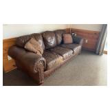 Used Brown Leather Sofa with Nailhead Trim and Throw Pillows