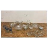 Collection of Glassware Including Bowls, Dishes, and Blue Stemmed Glasses