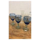 Collection of Glassware Including Bowls, Dishes, and Blue Stemmed Glasses