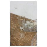 Collection of Glassware Including Bowls, Dishes, and Blue Stemmed Glasses