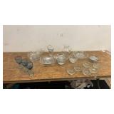 Collection of Glassware Including Bowls, Dishes, and Blue Stemmed Glasses