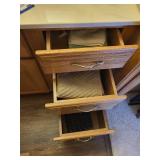 Collection of Hand Towels in Wooden Cabinet Drawers