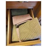 Collection of Hand Towels in Wooden Cabinet Drawers