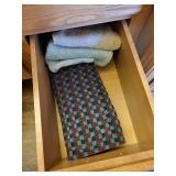 Collection of Hand Towels in Wooden Cabinet Drawers