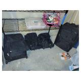 Collection of Black Rolling Suitcases and Assorted Holiday Decorations