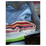 Collection of Quilting Fabrics and Supplies in Storage Totes