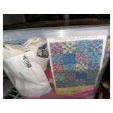 Collection of Quilting Fabrics and Supplies in Storage Totes